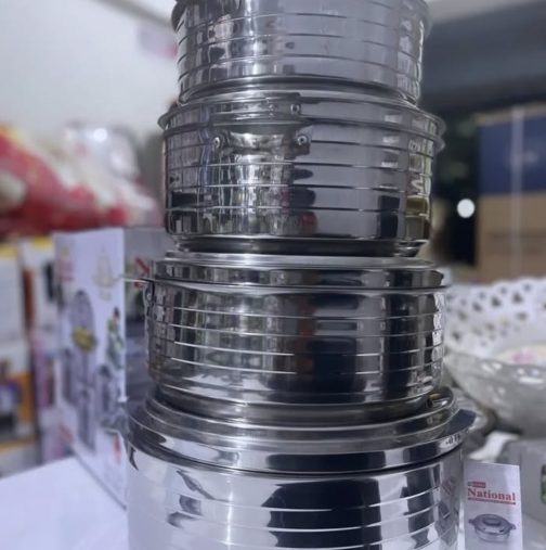 shows a stack of stainless steel cooking pots or containers