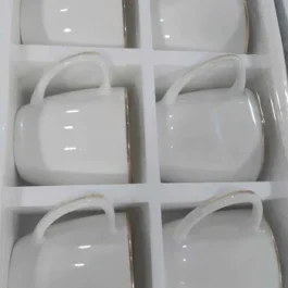 White Ceramic Tea Cups And A Matching Saucer